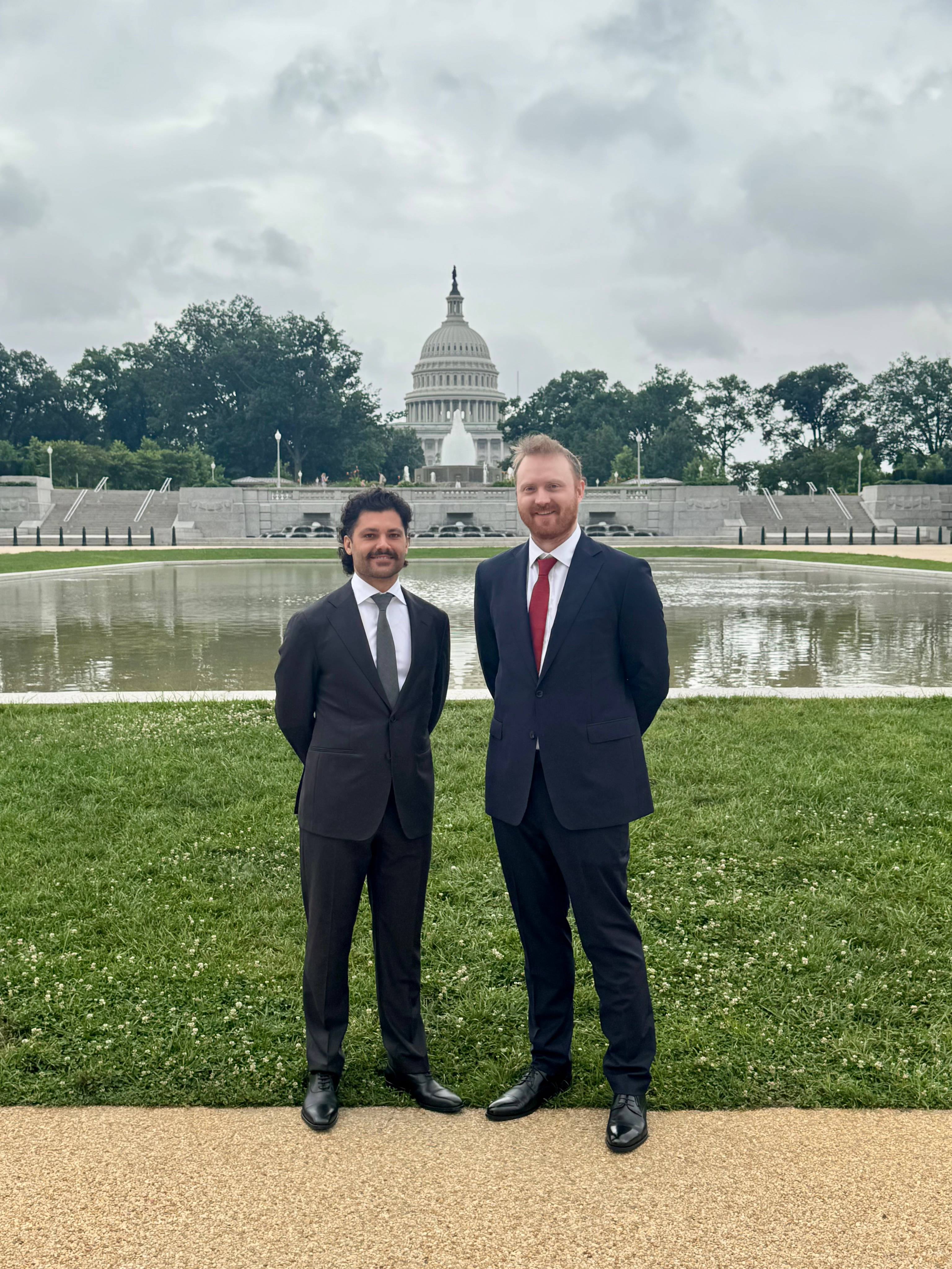 A render of three white cylindrical columns, against a warm creme background
